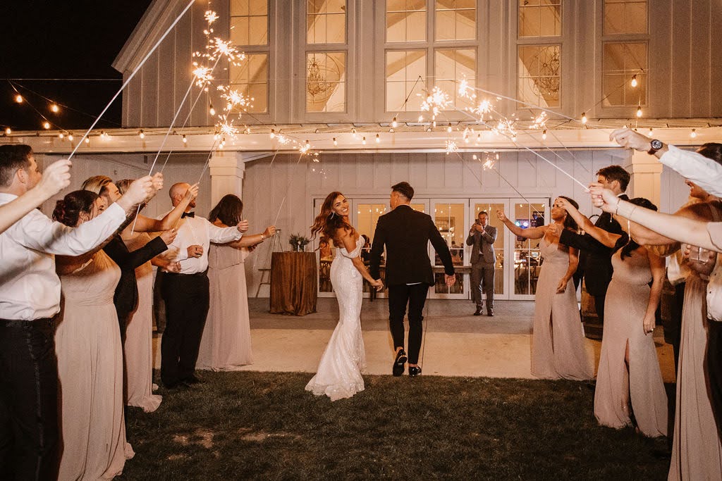 Sparkler exit with white barn at Providence Vineyard wedding venue