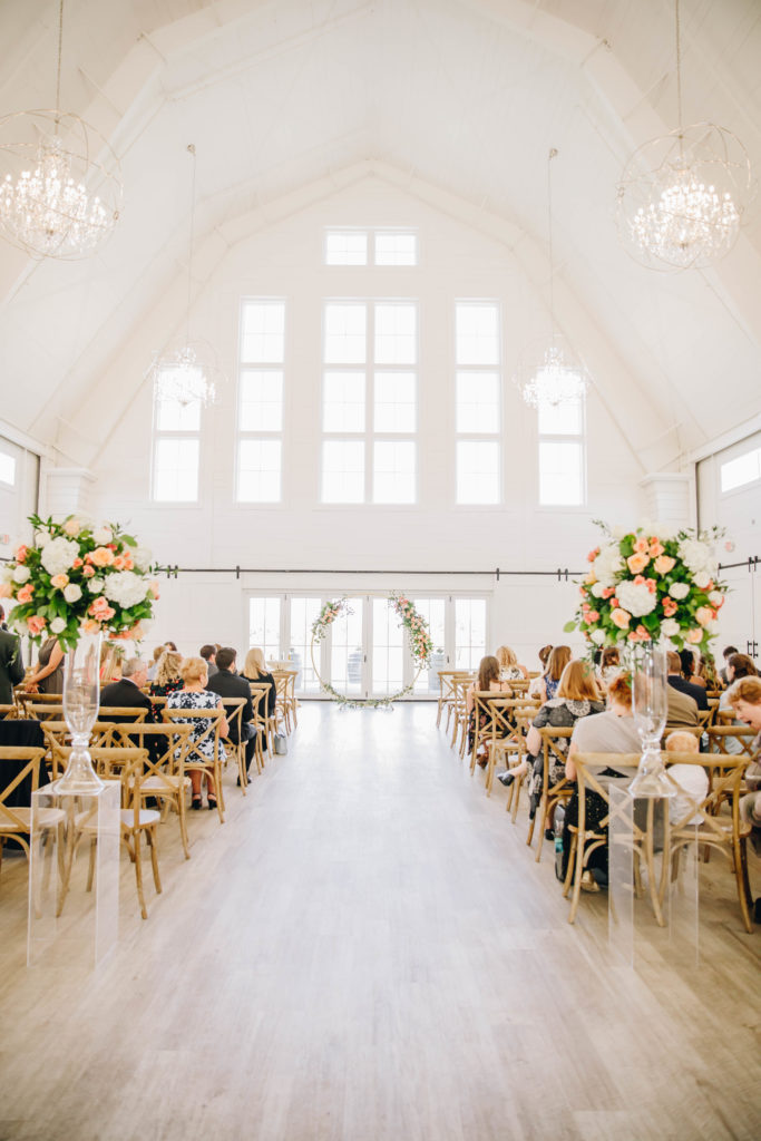 ceremony in white barn with window backdrop at Providence Vineyard Wedding Venue