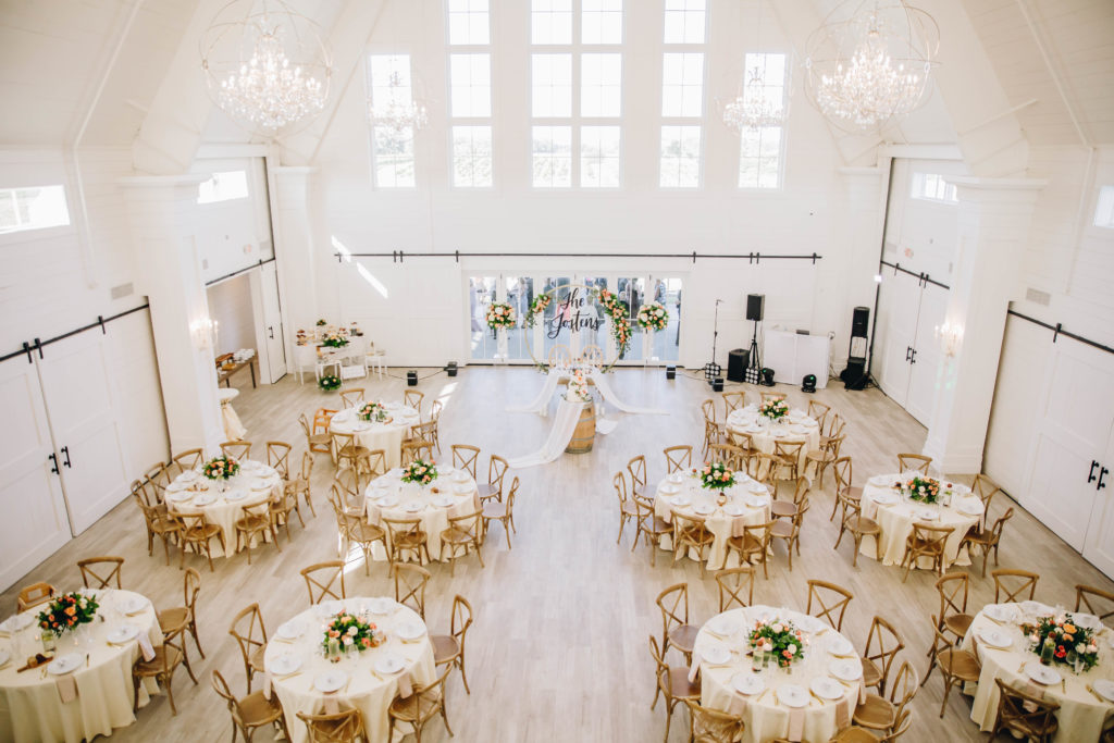 Indoor reception in white barn at Providence Vineyard wedding venue