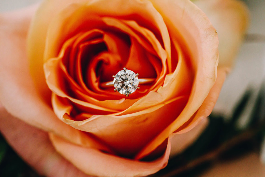 Engagement wedding ring inside rose florals at Providence vineyard wedding venue